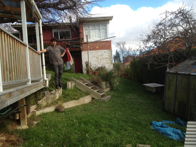 BEFORE - Sloping grass and rusting glasshouse